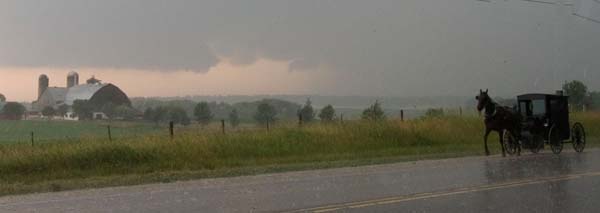 Horse and buggy crossing in front of a tornadic supercell.  